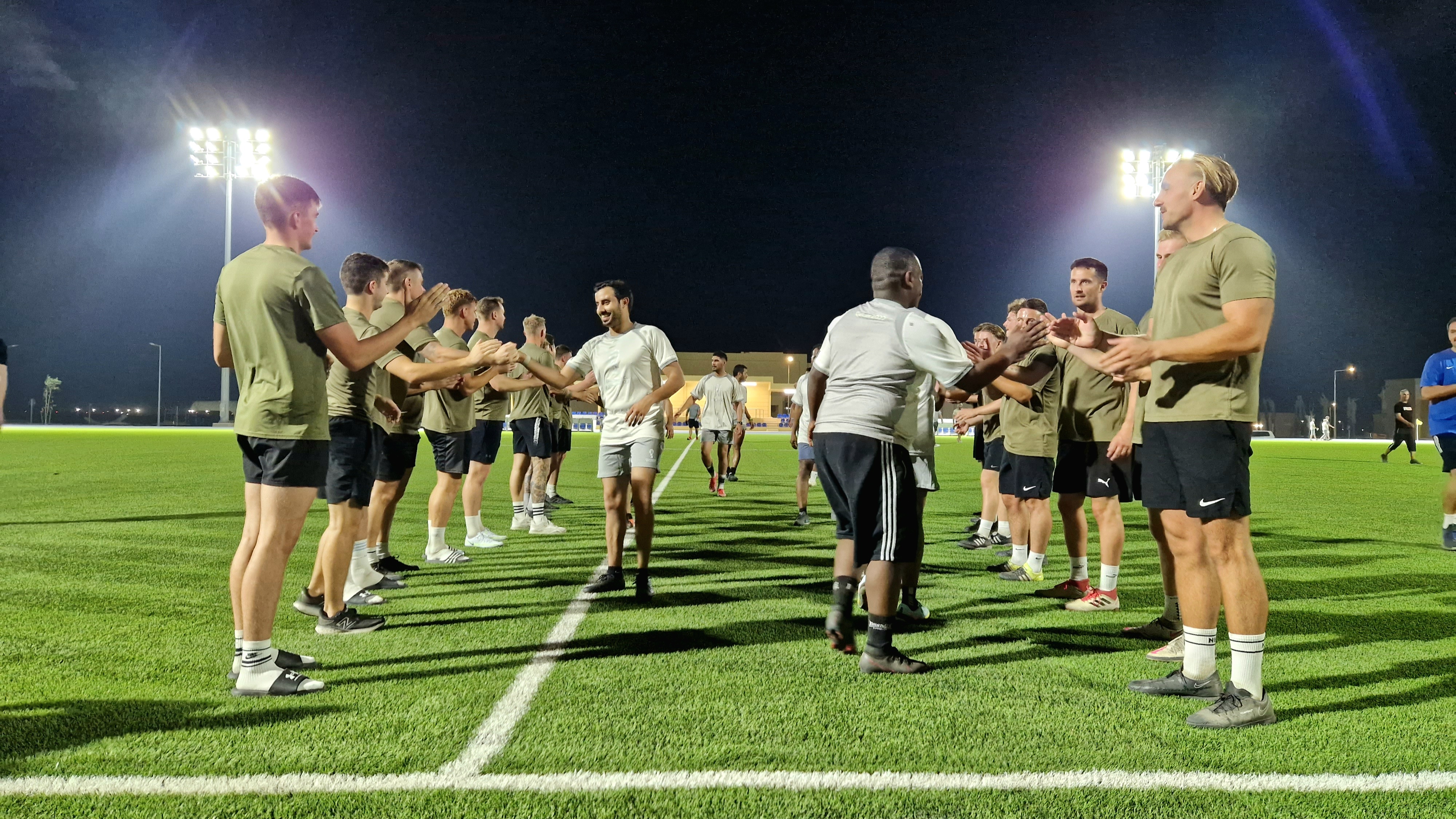 Image shows personnel and football players on the pitch.